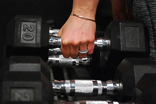 Model Shannon Grabbing Dumbell while comfortably wearing her Zealology Ring